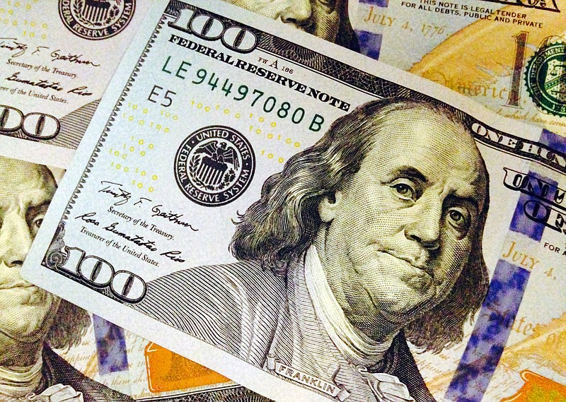 This Feb. 2, 2015, file photo, depicts a part of a U.S. $100 bill. The federal government is borrowing about one out of seven dollars it spends and steadily piling up debt -- to the tune of about $14 trillion held by investors. Over the long term, that threatens the economy and people's pocketbooks.