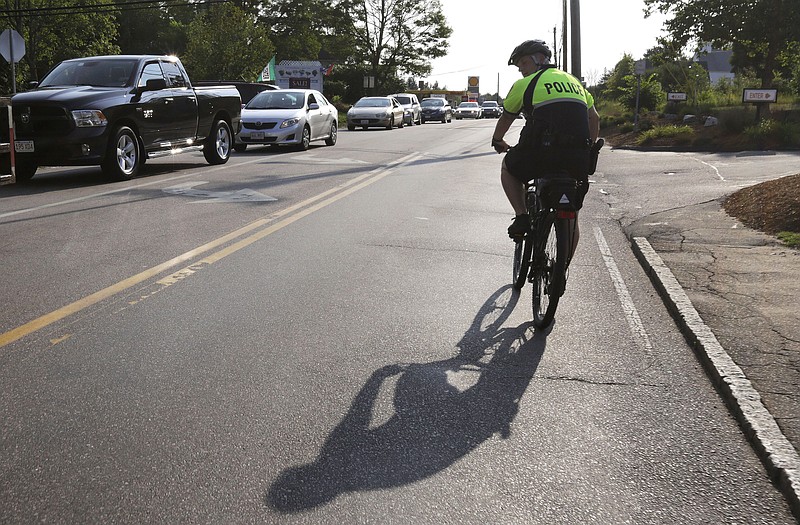 
              In this July 20, 2016 photo, police officer Matthew Monteiro watches for motorists who may be texting while patrolling on his bicycle during afternoon rush hour in East Bridgewater, Mass. Efforts to discourage drivers from texting have increased in recent years, but the consensus is that the problem is only getting worse. Police departments around the country have gotten creative in trying to get drivers to put down their phones. (AP Photo/Steven Senne)
            