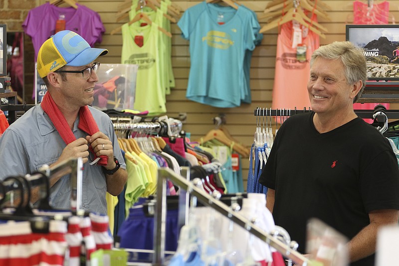 Staff Photo by Dan Henry / The Chattanooga Times Free Press- 8/18/16. Alan Outlaw, left, and Steve Bean converse inside of Fast Break Athletics on Thursday, August 18, 2016 about next weekend's Cam Run honoring the late Cameron Bean. 