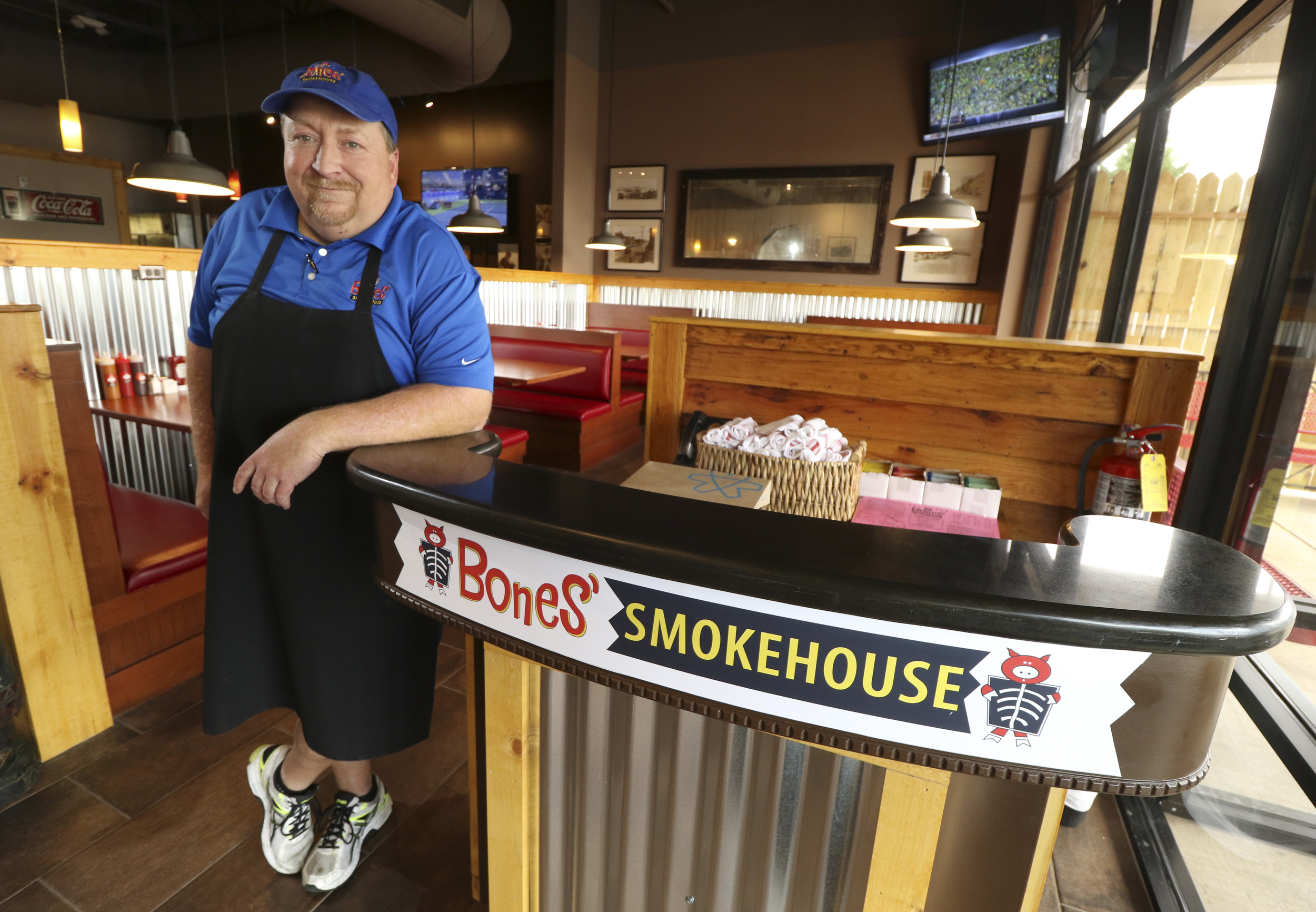 Tim Bishop, general manager and operation partner of Bones Smokehouse, stands in the restaurant's new location.
