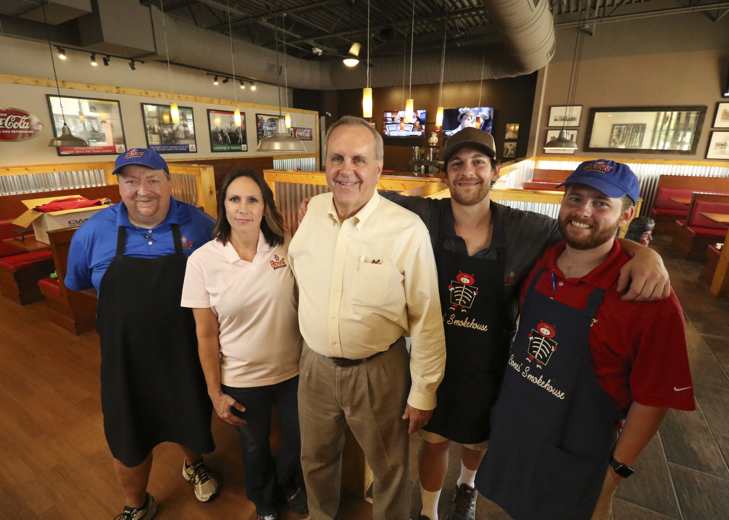 Tim Bishop, Adrian Catlin, Tim Hennen, Andrew Hennen and Jeffrey Hennen, from left, stand in the new location of Bones Smokehouse.
