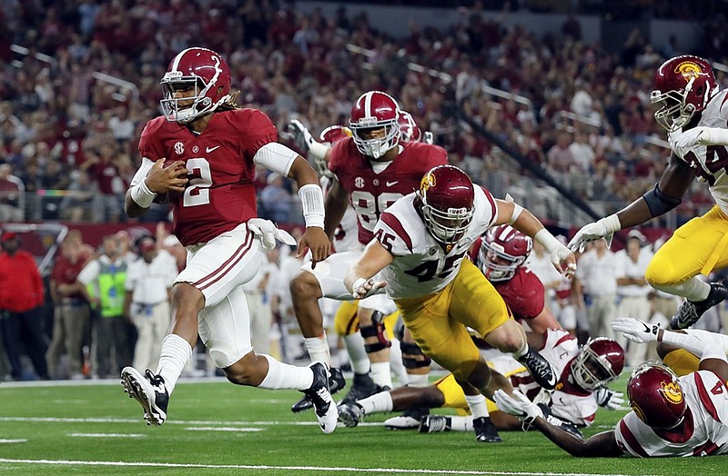Alabama freshman quarterback Jalen Hurts cruises into the end zone from 7 yards out during Saturday night's 52-6 dismantling of Southern California.