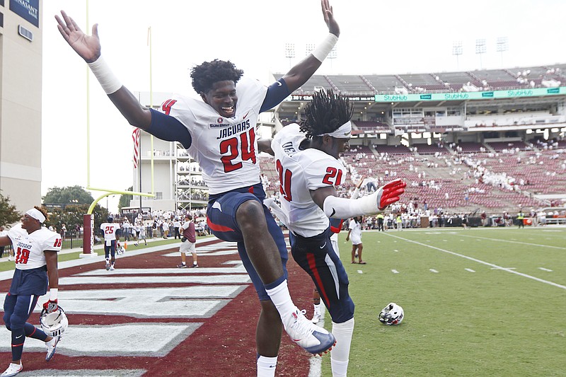 South Alabama cornerbacks Darian Mills (24) and Quinton Dent (21) celebrate their 21-20 win over Mississippi State in an NCAA college football game in Starkville, Miss., Saturday, Sept. 3, 2016. (AP Photo/Rogelio V. Solis)