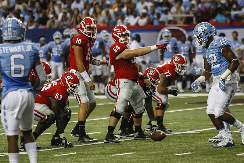 Georgia freshman quarterback Jacob Eason and senior center Brandon Kublanow prepare to run a play during Saturday night's 33-24 win over North Carolina in the Chick-fil-A Kickoff Classic.