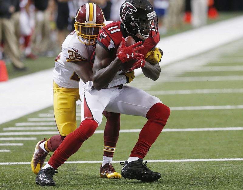In this Aug. 11, 2016, file photo, Atlanta Falcons wide receiver Julio Jones (11) makes a catch against Washington Redskins cornerback Bashaud Breeland during a preseason NFL football game in Atlanta. Coach Dan Quinn expects All-Pro receiver Jones to be full strength when the Falcons install their game plan for Sunday's opener against Tampa Bay. Jones sprained his ankle in the third preseason game at Miami, but Quinn believes he will fully participate on Wednesday, Sept. 7.