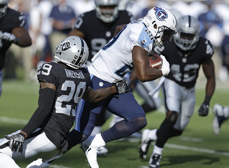 In this Aug. 27, 2016, file photo, Tennessee Titans running back DeMarco Murray carries the ball past Oakland Raiders cornerback David Amerson, left, during the first half of an NFL preseason football game in Oakland, Calif. New general manager Jon Robinson has sifted through the roster adding 21 new players, revamping the offense through a handful of trades and showing the door to a handful of high draft picks from the previous regime. His biggest moves landed DeMarco Murray for coach Mike Mularkey's run-oriented offense and included trading the No. 1 overall pick netted more picks that help add Heisman Trophy winner Derrick Henry.