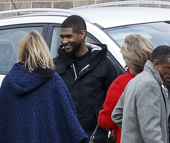 R&B artist Usher, third from right, stands with a group at a dedication Thursday, Feb. 12, 2015, during a visit to Orange Grove Center in Chattanooga.