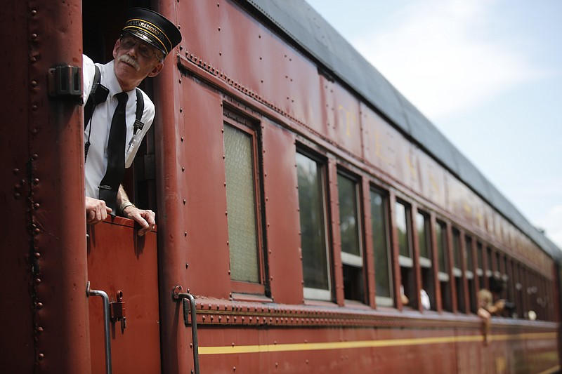 Conductor Augustus Frye looks from the window of a rail car as it leaves the station at a previous Railfest at the Tennessee Valley Railroad Museum.