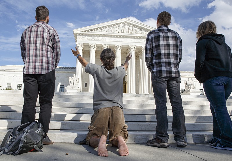 Pro-life advocates hold a prayer vigil on the plaza of the U.S. Supreme Court as it opens its session in October 2014.