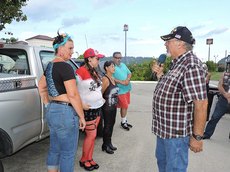 Master of ceremonies and event organizer Chuck Welch announces the contestants in the Rockabilly Girl Contest at August's event. From left are Cindy Hughes of Chattanooga, Megan Lee of Calhoun and Sandra King of Apison. Hughes ended up taking home the Best Rockabilly Girl trophy.