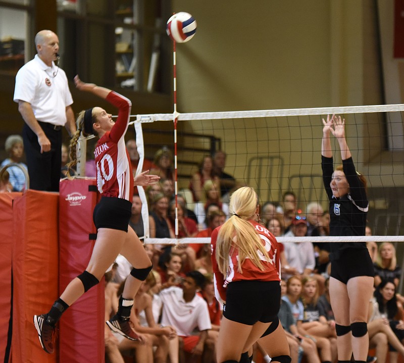 Baylor's Gabby Gray jumps to send the volleyball over as GPS's Emma Moore prepares to defend during Wednesday's match at Baylor. The Lady Red Raiders, ranked eighth nationally, won 25-16, 25-11, 25-8.