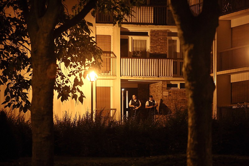 
              Police officers stand guard as they take part in a raid in Boussy-Saint-Antoine, east of Paris, Thursday, Sept. 8, 2016. French police detained three women planning 'imminent and violent action' after a standoff Thursday linked to a terrorism investigation into six gas canisters found in a car abandoned near Paris' Notre Dame Cathedral. (AP Photo/Thibault Camus)
            