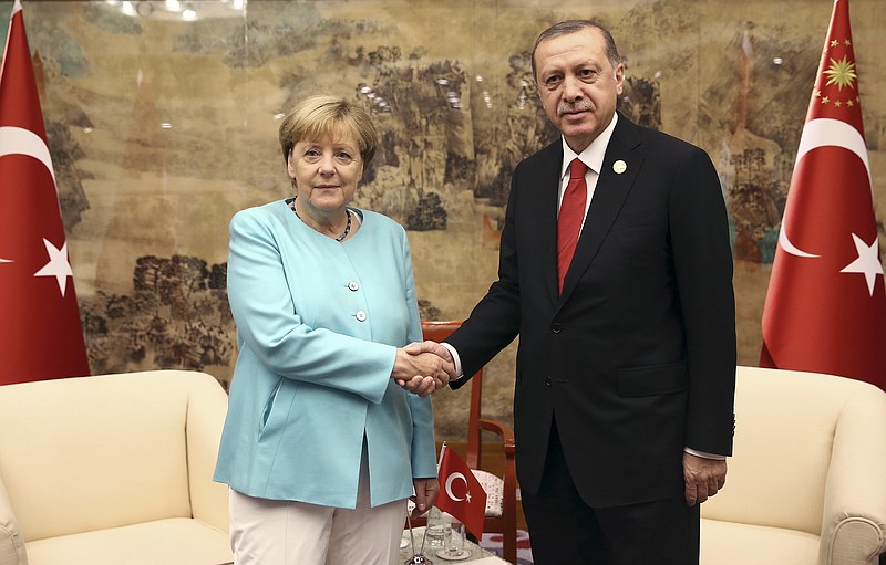 
              FILE - In this Sept. 4, 2016 file photo Turkish President Recep Tayyip Erdogan, right, and German Chancellor Angela Merkel pose for a photo before a bilateral meeting in Hangzhou in eastern China's Zhejiang province alongside the G20 Summit. (Kayhan Ozer/Pool Photo via AP, file)
            