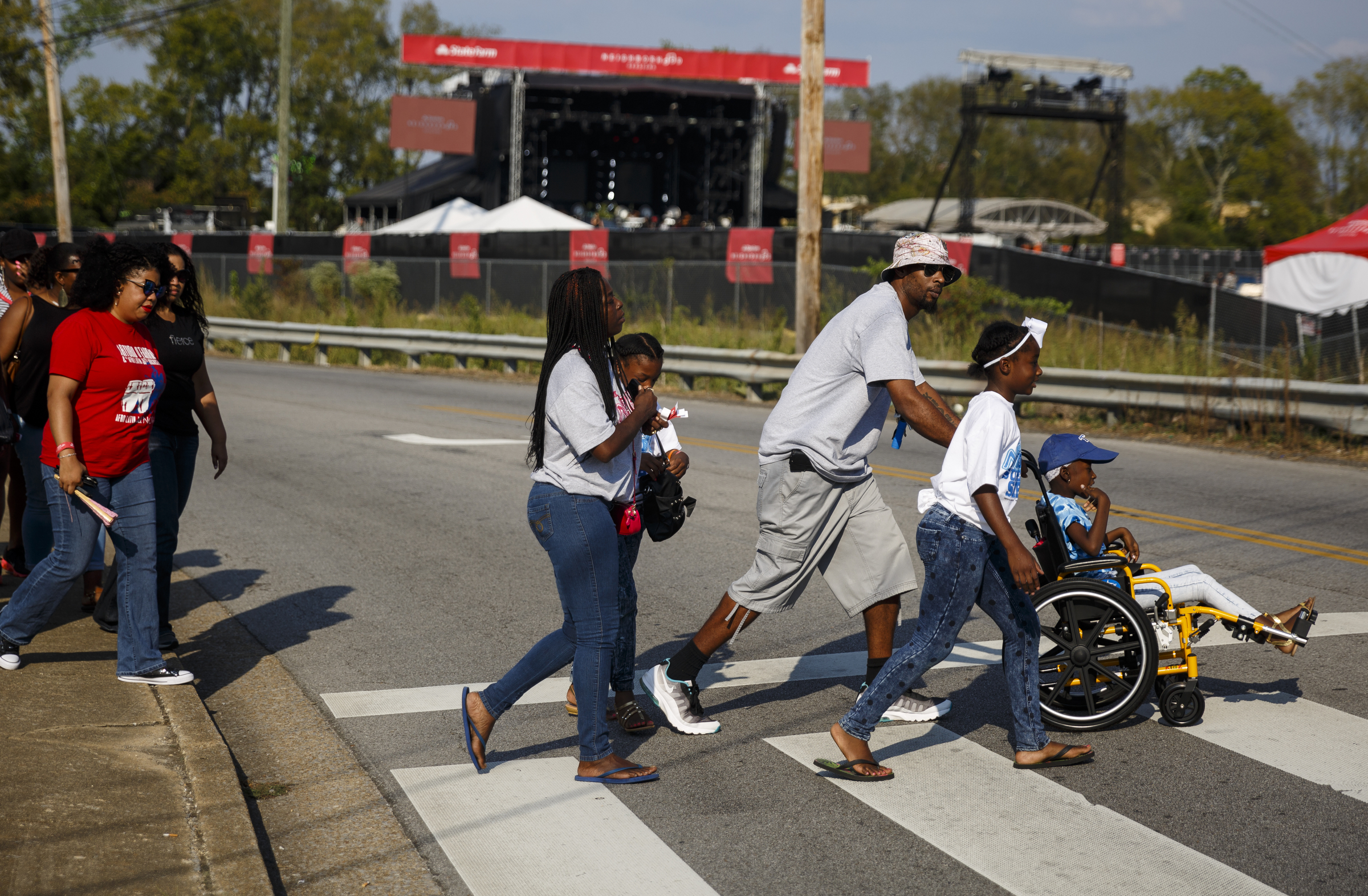 Fans cross the street to enter the closed venue before a performance by artist Usher at Dalewood Middle School, his former school, on Friday, Sept. 9, 2016, in Chattanooga, Tenn. The concert concluded a string of activities and benefits by the artist in his home town.