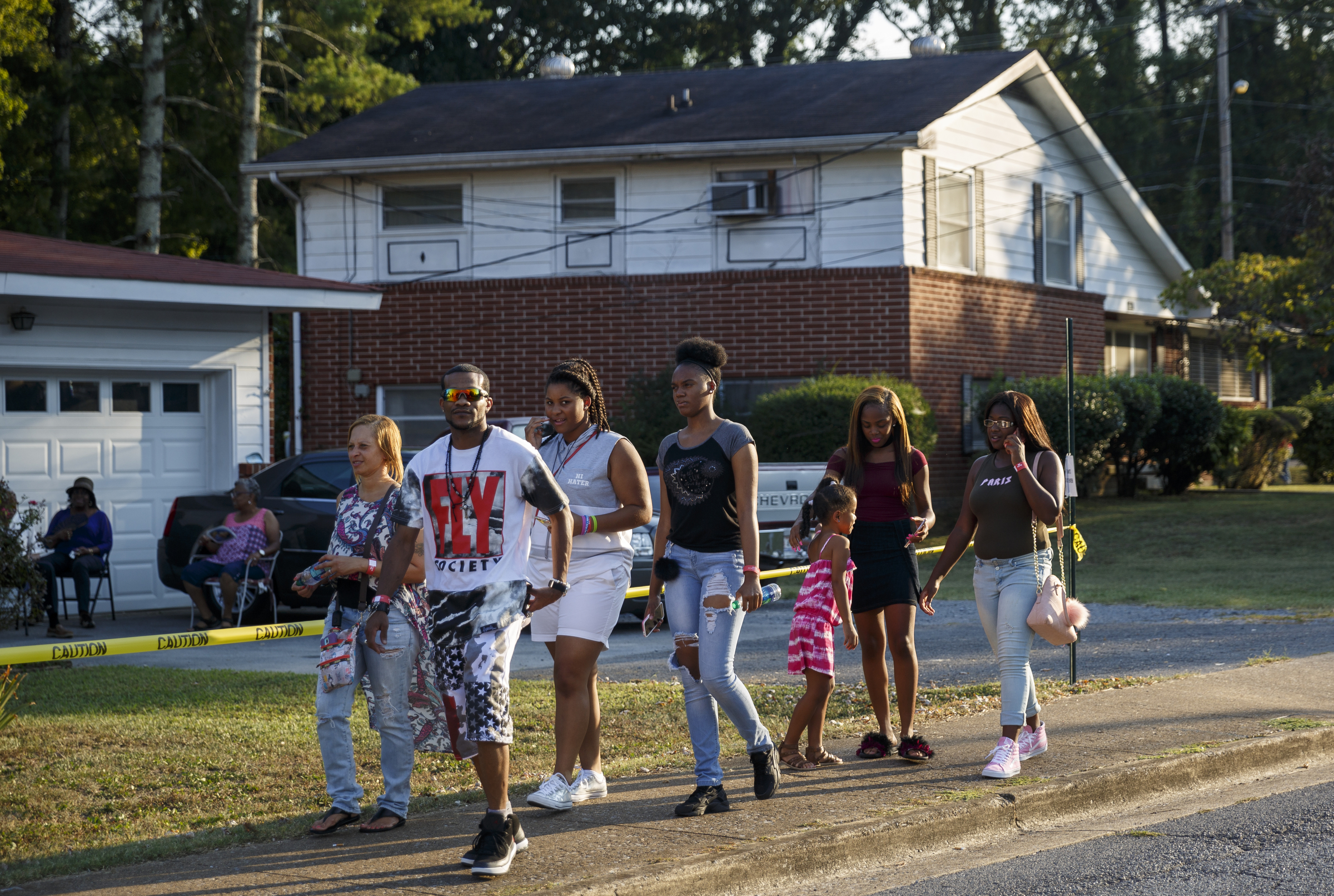 Fans walk past neighborhood homes to the closed venue before a performance by artist Usher at Dalewood Middle School, his former school, on Friday, Sept. 9, 2016, in Chattanooga, Tenn. The concert concluded a string of activities and benefits by the artist in his home town.