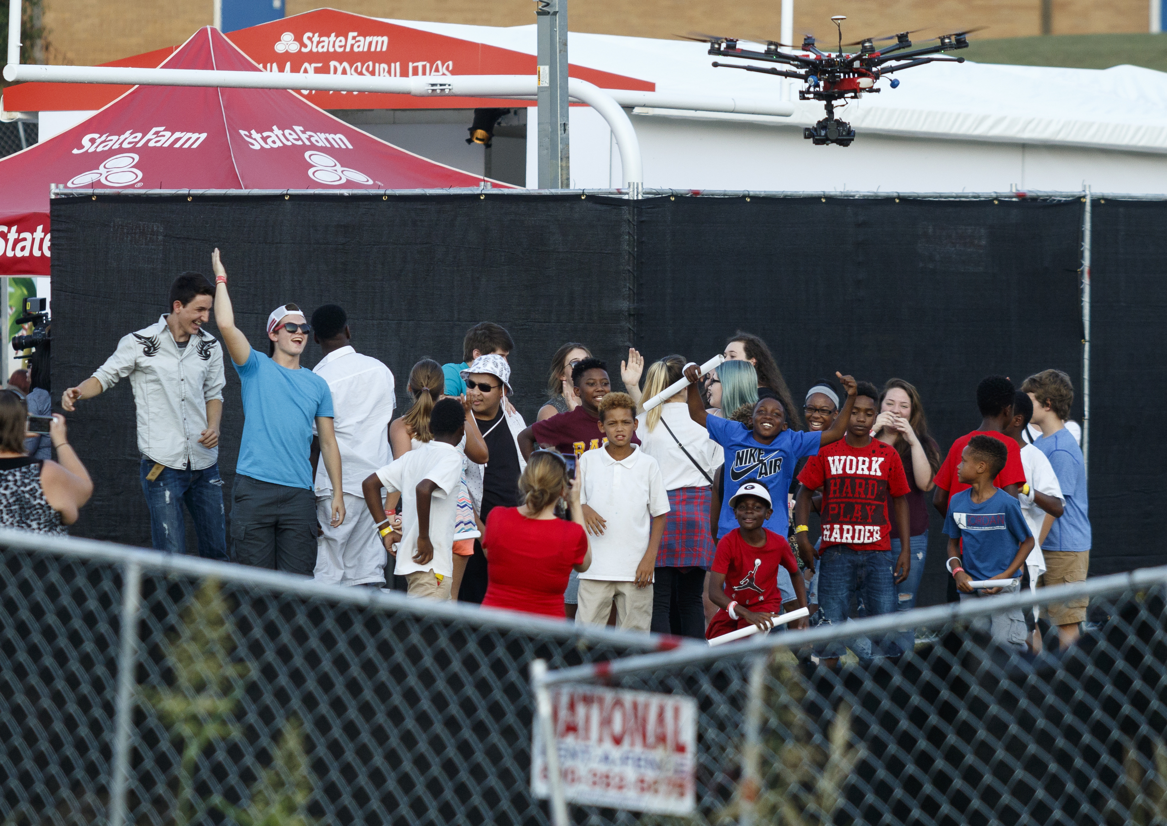 Fans inside the closed venue cheer for a camera drone before a performance by artist Usher at Dalewood Middle School, his former school, on Friday, Sept. 9, 2016, in Chattanooga, Tenn. The concert concluded a string of activities and benefits by the artist in his home town.