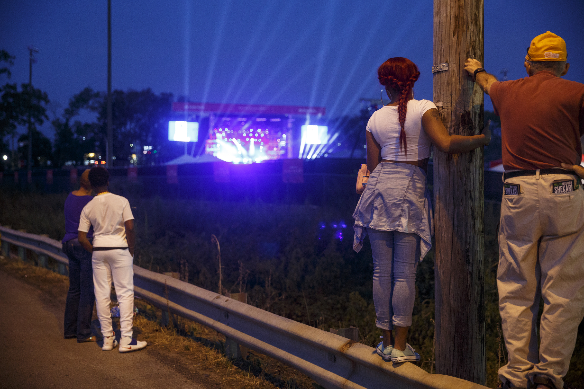 People watch a performance by artist Usher at Dalewood Middle School, his former school, from Shallowford Road on Friday, Sept. 9, 2016, in Chattanooga, Tenn. The concert concluded a string of activities and benefits by the artist in his home town.