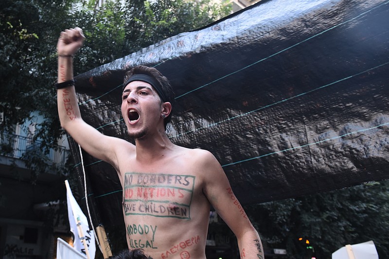 
              A refugee takes part in an anti-austerity protest in the northern port city of Thessaloniki, Greece, where Prime Minister Alexis Tsipras is due to speak at the 81th Thessaloniki International Trade Fair on the state of the nation's economy, on Saturday, Sept. 10, 2016. About 15,000 protesters are taking part in anti-government rallies before a visit to Greece by bailout inspectors and plans by the left-wing government to impose more austerity measures after years of economic hardship. (AP Photo/Giannis Papanikos)
            