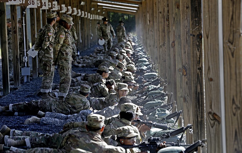 
              In this photo taken Wednesday, Aug. 17, 2016 U.S. Army drill sergeants stand over recruits during a live-fire marksmanship training course at Fort Jackson, S.C. While some of the Army's newest recruits may have grown up using rifles to hunt or take target practice, the drill sergeants charged with turning 45,000 civilians into warriors every year say more than half may have never touched a gun. (AP Photo/Gerry Broome)
            