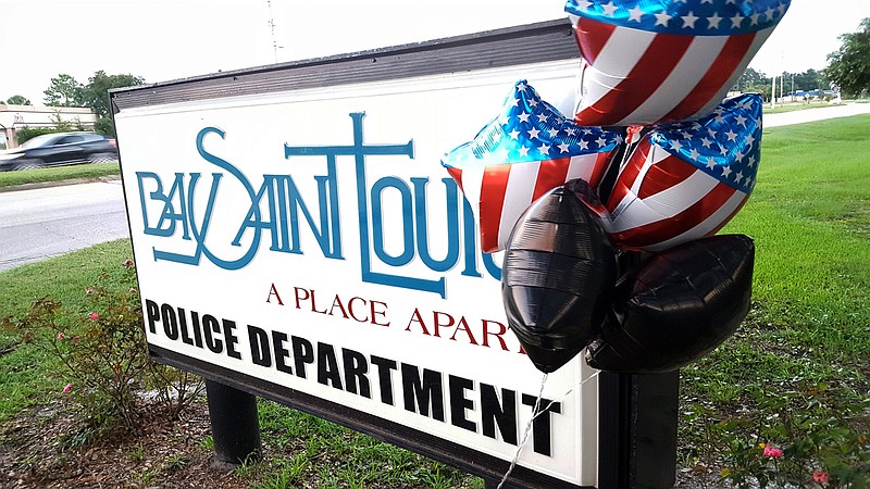 
              Balloons are attached to the Bay St. Louis Police Department sign on U.S.Highway 90, Friday, Sept. 9, 2016, in Bay St. Louis, Miss. The decorations are a tribute to Police Chief Mike De Nardo, who killed himself Thursday. DeNardo was suspended without pay shortly before his death. Mayor Les Fillingame says DeNardo was being investigated by the Hancock County Sheriff's Office, but he wouldn't discuss why. (Karen Nelson/The Sun Herald via AP)
            