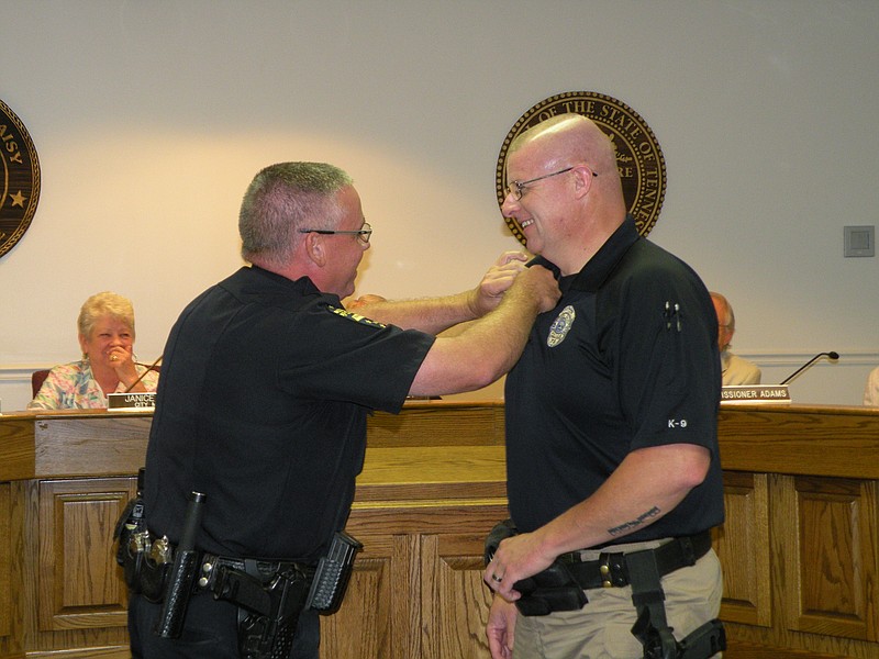 Jeff Gann, left, acting chief of the Soddy-Daisy Police Department, pins Officer Marty Petty with the Life Saving Award during the Aug. 18 Soddy-Daisy Commission meeting.