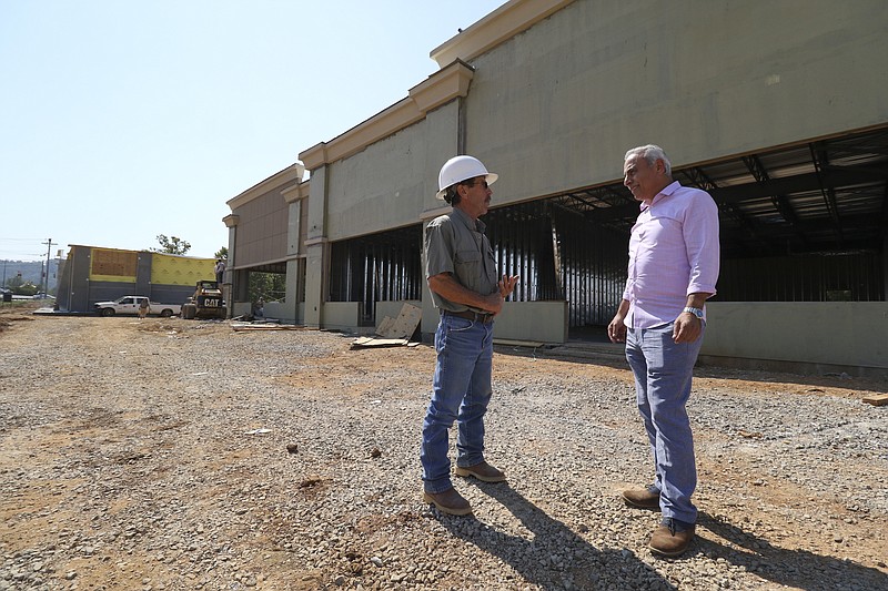  Site developer Bassam Issa, left, speaks to Jim Hill, superintendent of Winnsett-Hill Construction,about the progress being made at Wolftever Crossing. Wolftever Crossing will offer 12,000 square feet of retail space in two buildings on 1.7 acres.