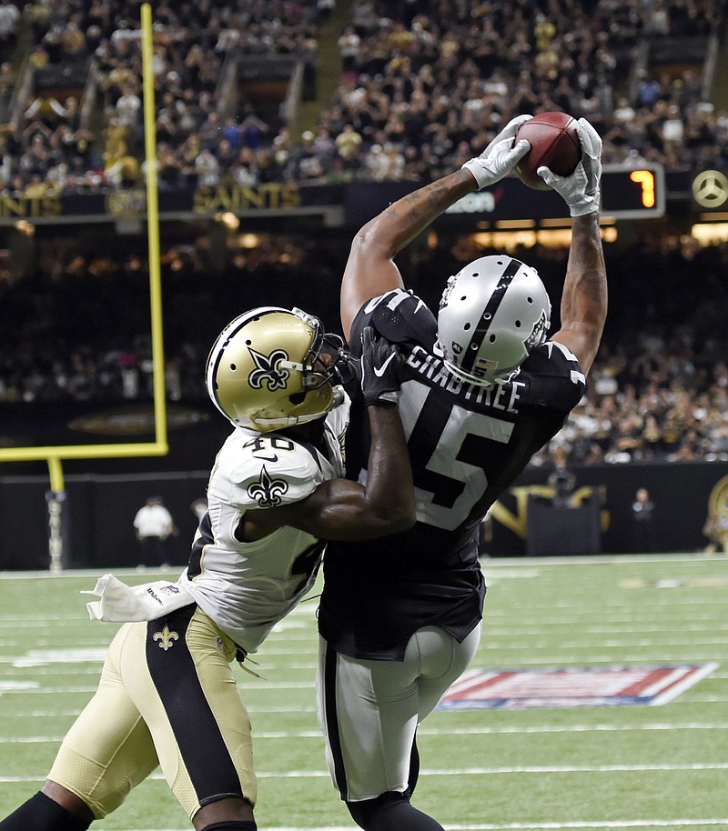 
              Oakland Raiders wide receiver Michael Crabtree (15) pulls in a touchdown reception over New Orleans Saints cornerback Ken Crawley (46) in the second half of an NFL football game in New Orleans, Sunday, Sept. 11, 2016. (AP Photo/Bill Feig)
            