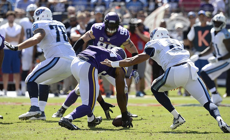 Minnesota Vikings defensive end Danielle Hunter, center, recovers a fumble by Tennessee Titans quarterback Marcus Mariota (8) and returns it 24 yards for a touchdown in the second half of an NFL football game Sunday, Sept. 11, 2016, in Nashville, Tenn. (AP Photo/Mark Zaleski)