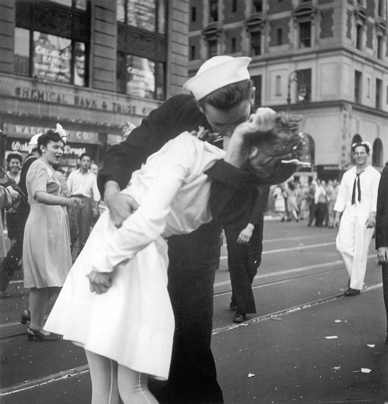
              FILE - In this Aug. 14, 1945 file photo provided by the U.S. Navy, a sailor and a nurse kiss passionately in Manhattan's Times Square, as New York City celebrates the end of World War II. The woman who was kissed by an ecstatic sailor in Times Square celebrating the end of World War II has died at the age of 92. Greta Zimmer Friedman's son says his mother died Thursday, Sept. 8, 2016, at a hospital in Richmond, Virginia. She died from complications of old age, he said. (AP Photo/U.S. Navy/Victor Jorgensen, File)
            