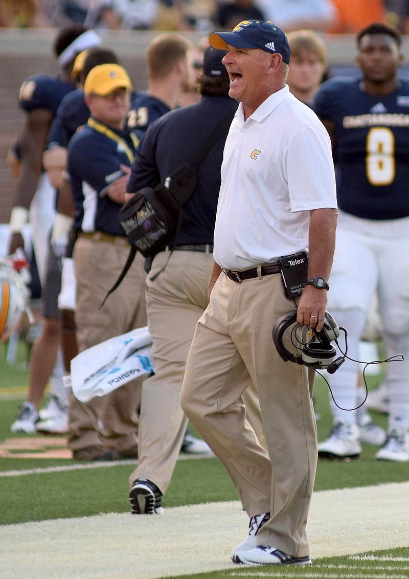 UTC head coach Russ Huesman shouts instructions along the sidelines.  The University of Tennessee/Chattanooga Mocs hosted the Shorter University Hawks in NCAA football action on Sept. 1, 2016. 