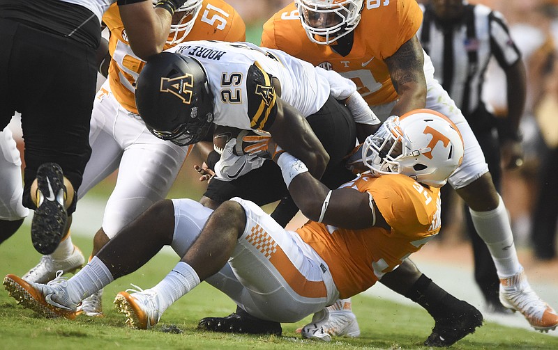 FILE -- In this Sept. 1, 2016 file photo, Tennessee linebacker Darrin Kirkland Jr. tackles Appalachian State running back Jalin Moore (25) during a NCAA football game in Knoxville, Tenn. Tennessee will be missing two defensive starters for Saturday's game against Ohio with Kirkland and LaTroy Lewis out with injured ankles. (Saul Young/Knoxville News Sentinel via AP, File)