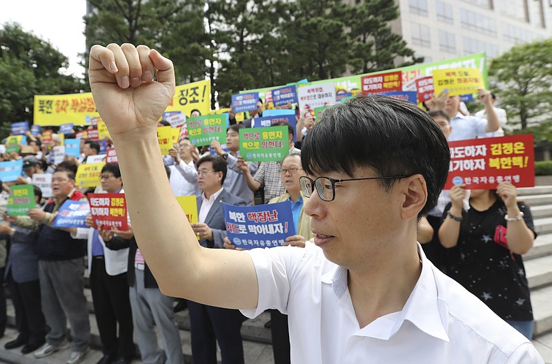 
              South Korean shout slogans during a rally denouncing North Korea's latest nuclear test in Seoul, South Korea, Monday, Sept. 12, 2016. North Korea is capable of detonating another nuclear device anytime at one of its unused tunnels at the country's main atomic test site, Seoul official said Monday, three days after the country carried out its fifth bomb explosion. The letters read "Overthrow Kim Jong Un." (AP Photo/Lee Jin-man)
            