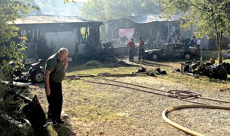 A trailer stands in ruins at the scene of a fire Tuesday morning in the Pond Springs Community of Chickamauga. The fire claimed the lives of a 6 year old and an 8 month old.