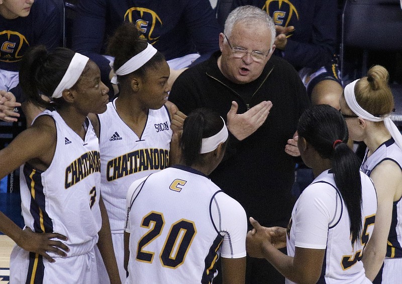 UTC women's basketball coach Jim Foster talks to players at the start of the 2nd half during the Mocs' final season home basketball game against ETSU at McKenzie Arena on Saturday, Feb. 27, 2016, in Chattanooga, Tenn.