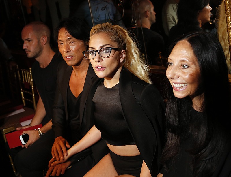 
              Lady Gaga, second from right, poses for pictures before the Brandon Maxwell Spring 2017 collection is modeled during Fashion Week at the Russian Tea Room in New York, Tuesday, Sept. 13, 2016. (AP Photo/Seth Wenig)
            