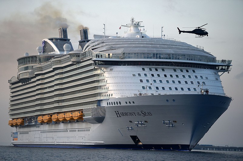 
              FILE - In this May 17, 2016 file photo, the world's largest passenger ship, MS Harmony of the Seas, owned by Royal Caribbean, makes her way up Southampton Water into Southampton, England. A crewmember on the world's largest cruise ship has died and four others were injured when a lifeboat fell from the deck into the water during a rescue drill, the operator and officials in the French port of Marseille said Tuesday. Julien Ruas, a deputy mayor of Marseille, told the AP Tuesday that the lifeboat fell 10 meters (33 feet) or so from the fifth deck of the ship into the sea with the five crew members aboard. He identified the dead crewmember as a 42-year-old Filipino. Circumstances of the accident are still unclear. (Andrew Matthews/PA via AP, file)
            