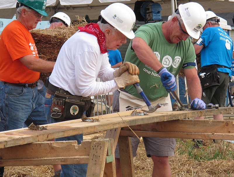 Former President Jimmy Carter, center, works on a Habitat for Humanity construction project on Monday, Aug. 22, 2016 in Memphis. On Monday, Carter said he thought he had just a few weeks to live during his battle with cancer a year ago. "Now I feel pretty certain about my cure and the cancer being in remission, but the doctors are still keeping an eye on me," he said.