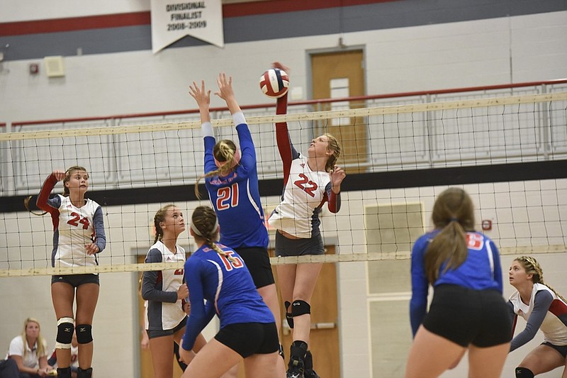 Ooltewah's Sidney Killingsworth (22) puts the ball over the net as Cleveland's Emma Flowers defends during their match earlier this month at Ooltewah.