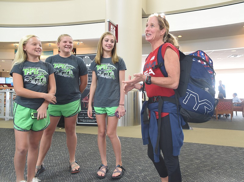 Liz Baker, right, a U.S. Paralympian from Signal Mountain, enjoys a moment with her Chattanooga Track Club members she mentors upon arrival at the Chattanooga Metropolitan Airport on Wednesday. From left are, Emily Thomson<cq>, Anna Thomson, Taylor Milliron and Baker.