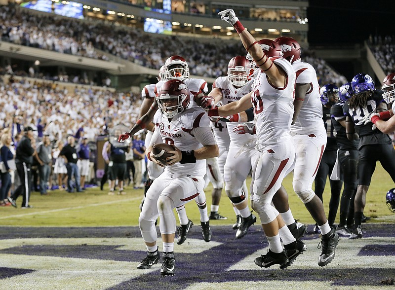 Arkansas quarterback Austin Allen (8) celebrates his touchdown run with teammates in double overtime against TCU in the 41-38 Arkansas win in an NCAA college football game, Saturday, Sept. 10, 2016, in Fort Worth, Texas. (AP Photo/Tony Gutierrez)
