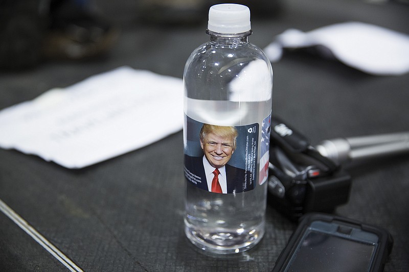 Donald Trump brand water bought by reporters at a rally near Milwaukee in August. Trump's international financial interests are questioned by Newsweek. (Damon Winter/The New York Times)