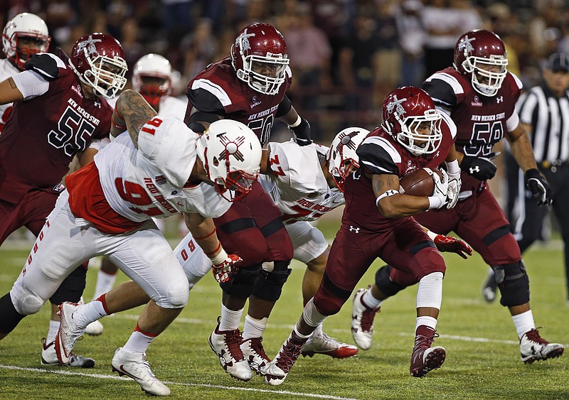 New Mexico State's Xavier Hall outruns New Mexico's defense during last Saturday's game in Las Cruces. New Mexico, which lost 32-31, heads east this week as an underdog to take on Rutgers.