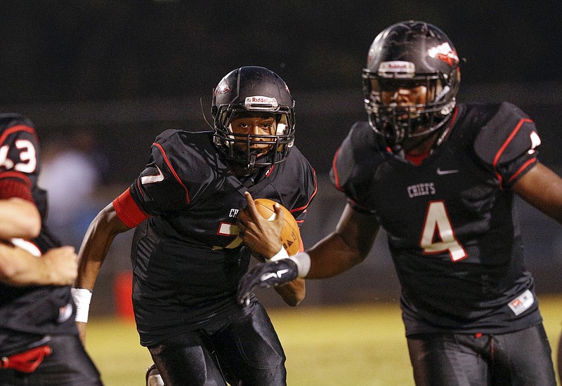 North Jackson quarterback Trey Harris, left, carries behind teammate Omar Brown during their prep football game against DAR at North Jackson High School on Thursday, Sept. 17, 2015, in Stevenson, Ala.