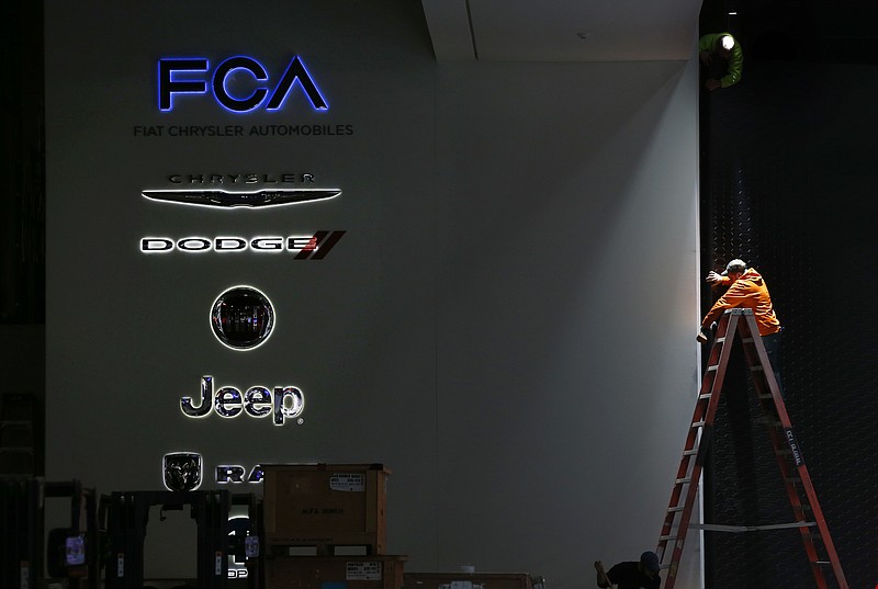 
              FILE - In this Thursday, Jan. 7, 2016, file photo, a worker prepares the Fiat Chrysler Automobiles area for the North American International Auto Show in Detroit. Fiat Chrysler Automobiles announced Thursday, Sept. 15, 2016, that the company is recalling more than 1.9 million vehicles worldwide because their air bags might not deploy in a crash. The recall affects certain Chrysler, Dodge, Jeep and Lancia vehicles from the 2010-2014 model years. (AP Photo/Paul Sancya, File)
            