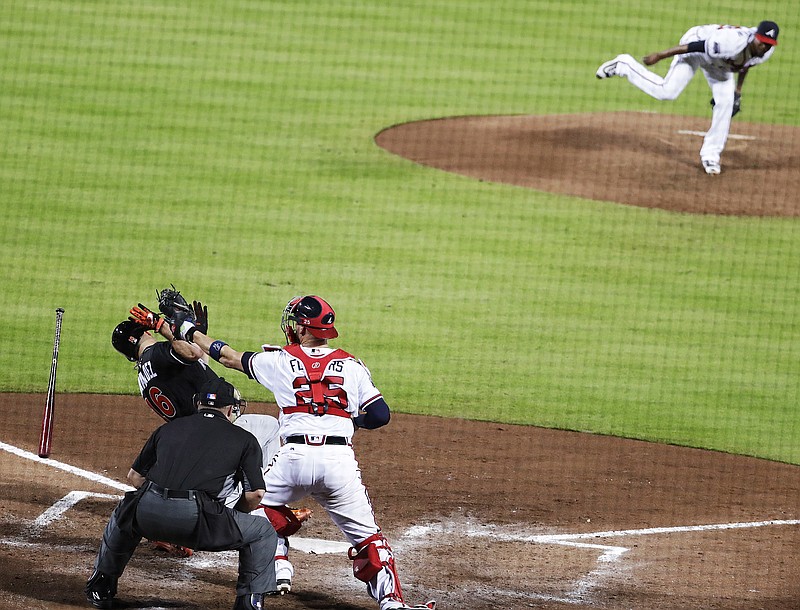Miami Marlins' Jose Fernandez, left, falls to the ground to get out of the way of a high pitch by Atlanta Braves' starting pitcher Julio Teheran, top right, during the fifth inning of a baseball game in Atlanta, Wednesday, Sept. 14, 2016. (AP Photo/David Goldman)