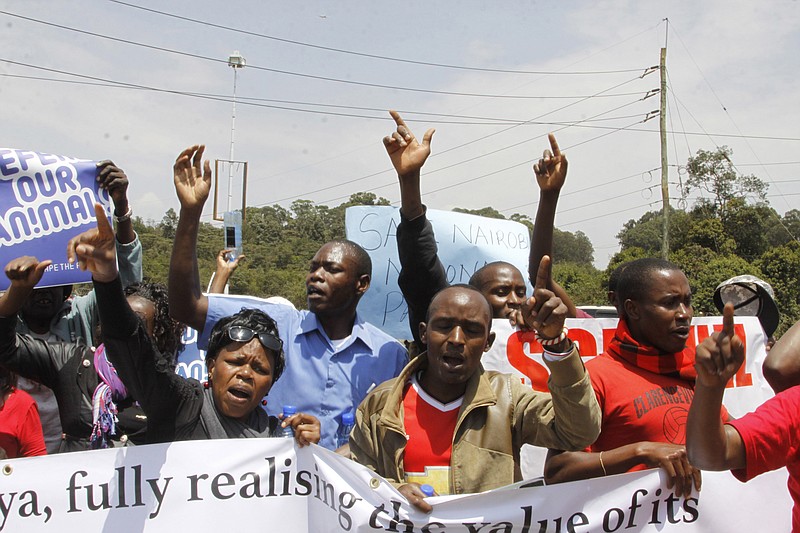 
              Kenyans hold up signs as they attend a protest to protect the Nairobi National Park in Nairobi, Friday, Sept. 16, 2016. Dozens of angry people have marched in the Kenyan capital Nairobi to protest plans to build a railway line over a national park. The protesters included conservationists and others who wore T-shirts and carried banners saying "don't rape our park." (AP Photo/Khalil Senosi)
            