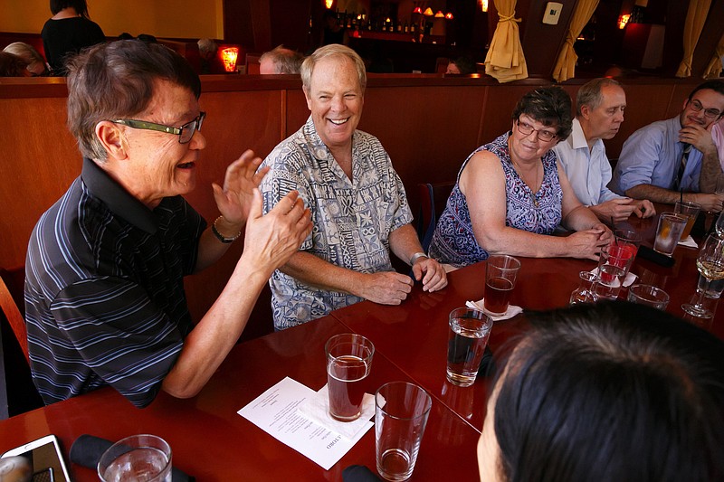 Joseph Huang, left, and Robert Bangs chat during a Prostate Club dinner gathering. (Erika Schultz/Seattle Times/TNS)