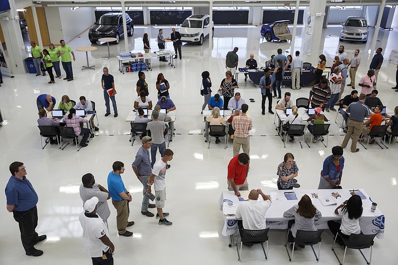 People gather to apply for jobs at Volkswagen's career fair at its area manufacturing plant Friday, Sept. 16, 2016, in Chattanooga, Tenn. The factory plans to hire 1,100 more workers.