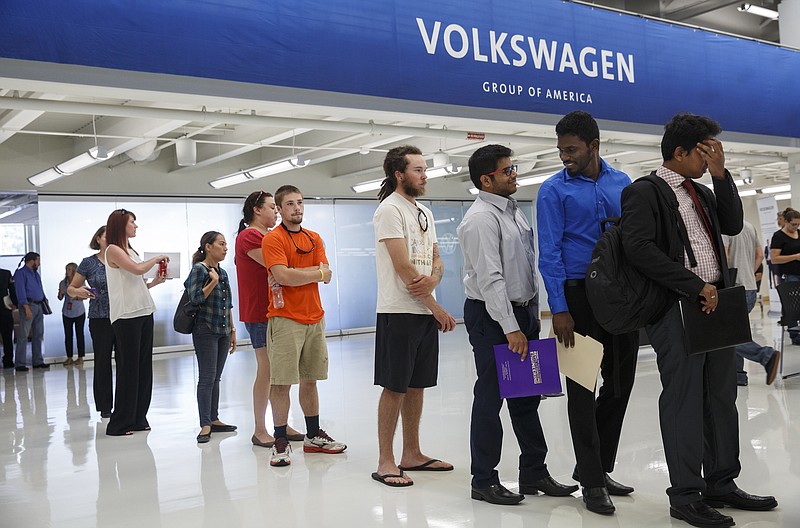 People seeking employment wait in line at Volkswagen's career fair at its area manufacturing plant Friday, Sept. 16, 2016, in Chattanooga, Tenn. The factory plans to hire 1,100 more workers.