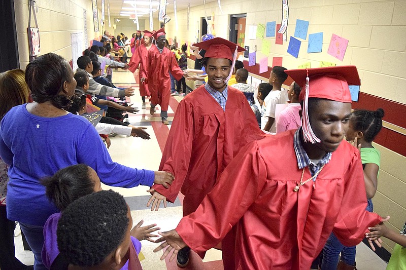 Brainerd Seniors process pass the cheering students on the decorated second floor of Orchard Knob Elementary.  The 2016 graduating class of Brainerd High School walked through the halls of Orchard Knob Elementary in their caps and gowns, as a representation of the "vision" for where the elementary students will one day be.  